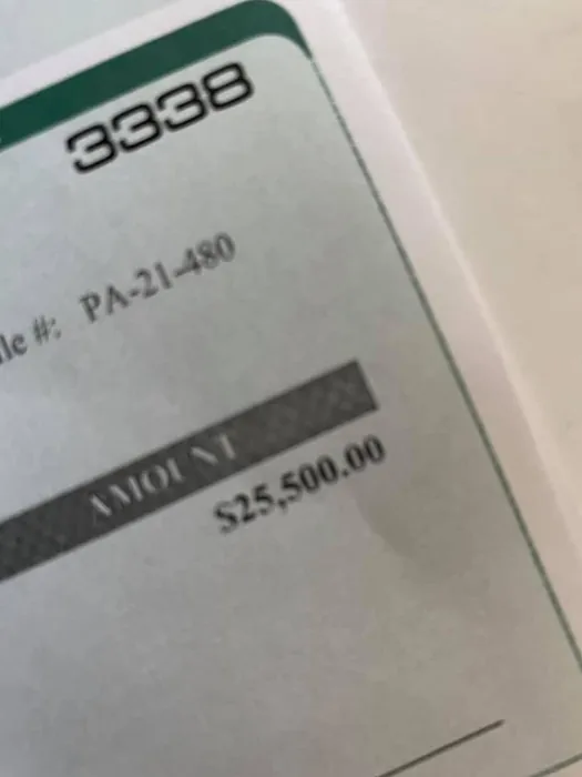 Close-up of the cheque corner: file PA-21-480, amount $25,500.00.